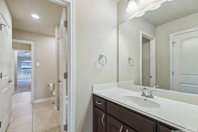 full bathroom featuring toilet, recessed lighting, tile patterned flooring, baseboards, and vanity