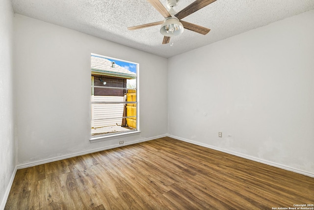 unfurnished room featuring baseboards, a textured ceiling, a ceiling fan, and wood finished floors