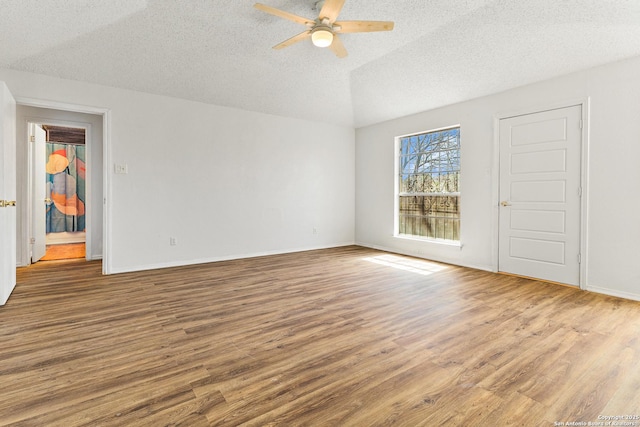 unfurnished room with ceiling fan, baseboards, a textured ceiling, and wood finished floors