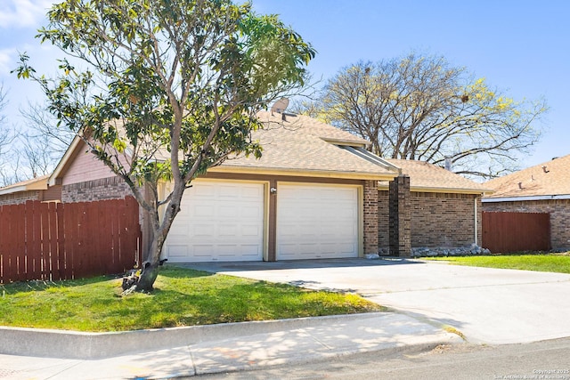 view of front of home featuring brick siding, driveway, a shingled roof, and fence