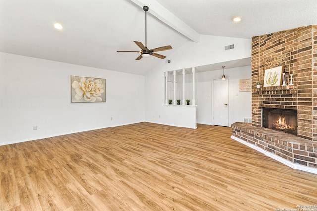 unfurnished living room with visible vents, beamed ceiling, wood finished floors, a fireplace, and ceiling fan