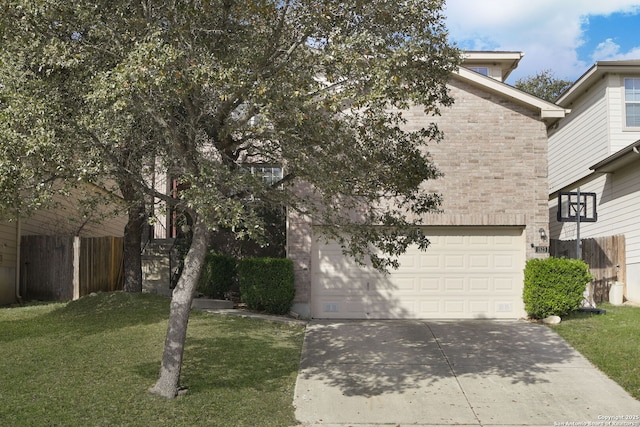 view of property hidden behind natural elements with a front yard, fence, driveway, a garage, and brick siding