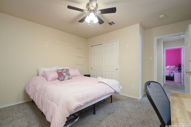 carpeted bedroom with visible vents, baseboards, a closet, and ceiling fan