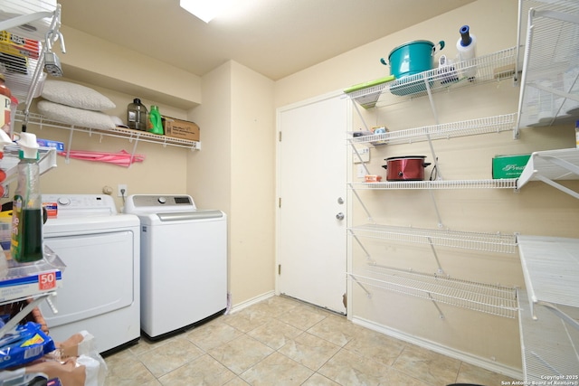 washroom featuring laundry area, light tile patterned floors, and separate washer and dryer