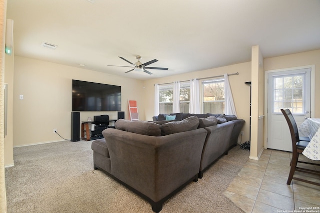 living room featuring visible vents, plenty of natural light, baseboards, and a ceiling fan