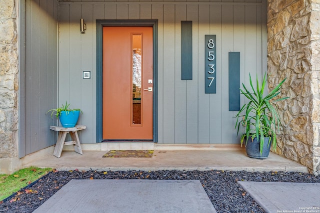 property entrance with stone siding