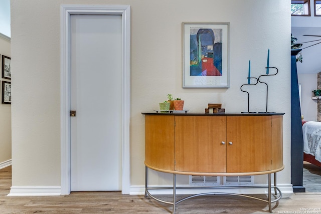 bar featuring baseboards and wood finished floors