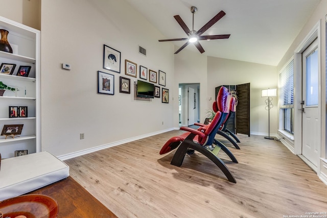 playroom with baseboards, visible vents, light wood finished floors, and high vaulted ceiling