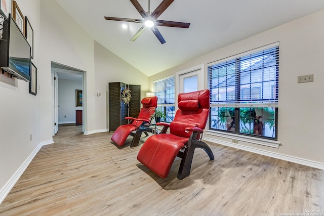 sitting room with high vaulted ceiling, a ceiling fan, baseboards, and wood finished floors