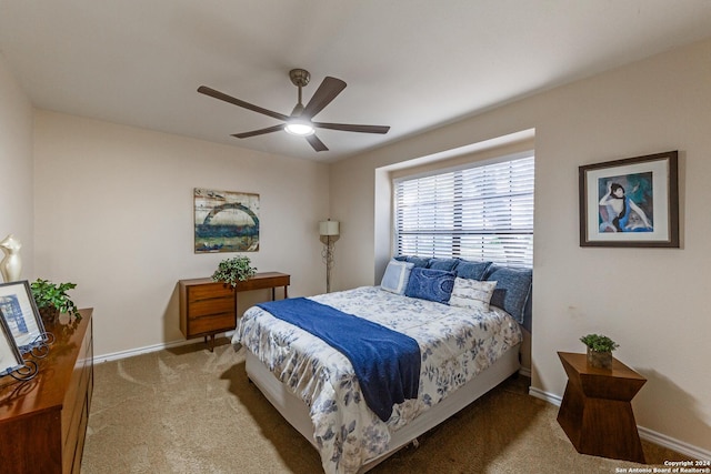 carpeted bedroom with baseboards and ceiling fan