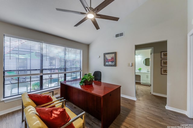 office area featuring dark wood finished floors, vaulted ceiling, visible vents, and ceiling fan