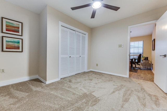 unfurnished bedroom with a closet, baseboards, and carpet flooring