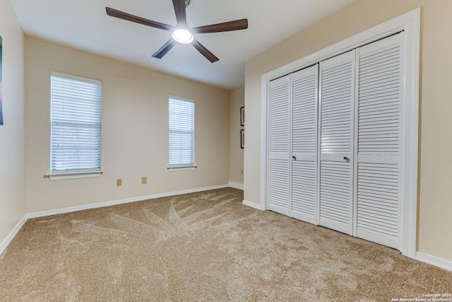 unfurnished bedroom with a closet, baseboards, and carpet floors