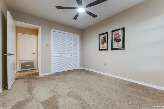 unfurnished bedroom featuring visible vents, a ceiling fan, a closet, carpet, and baseboards