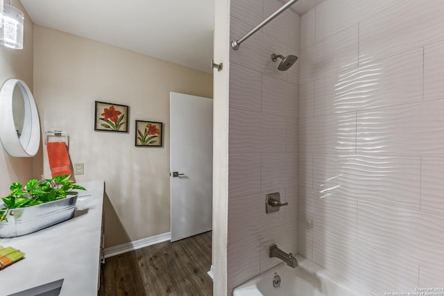 full bathroom featuring vanity, wood finished floors, baseboards, and shower / bath combination