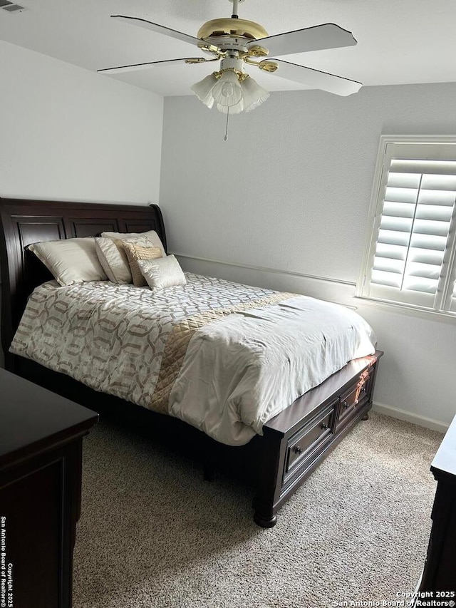 carpeted bedroom featuring visible vents, a ceiling fan, and baseboards