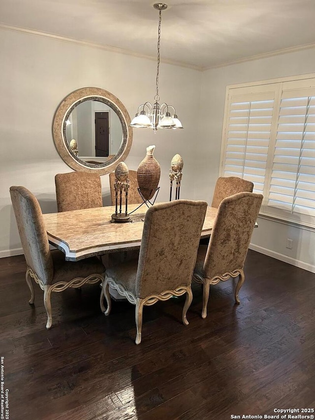 dining room featuring a notable chandelier, baseboards, dark wood-style flooring, and ornamental molding