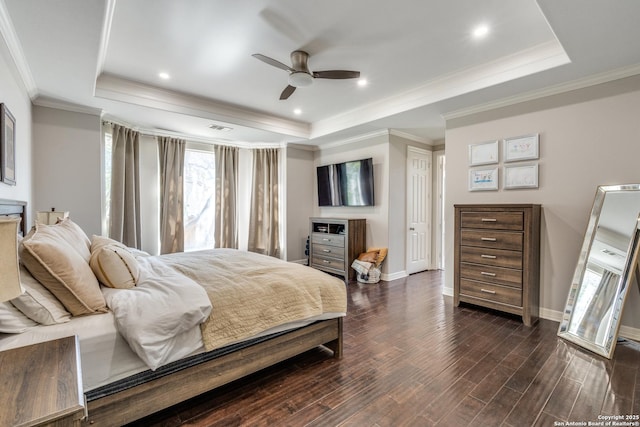 bedroom with a tray ceiling, baseboards, ornamental molding, and dark wood-style flooring