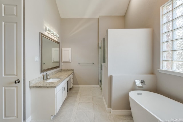 full bath featuring baseboards, a stall shower, a freestanding tub, tile patterned floors, and vanity