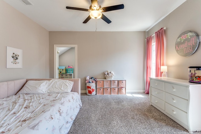 carpeted bedroom with visible vents, baseboards, and a ceiling fan