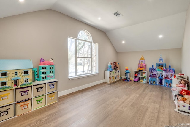 game room with lofted ceiling, baseboards, visible vents, and light wood-type flooring