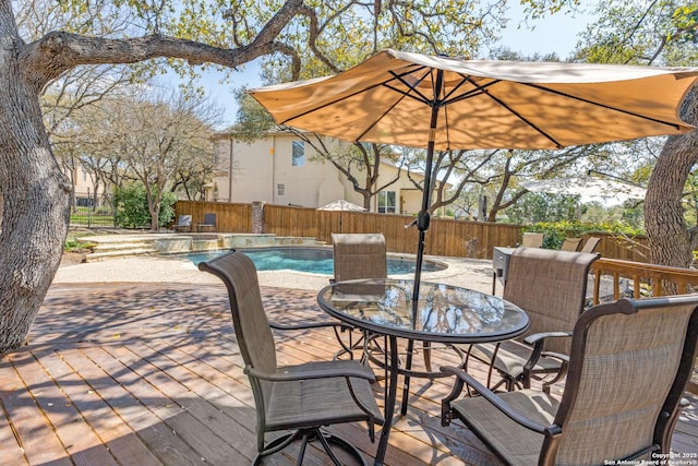 view of patio / terrace featuring a fenced in pool, a fenced backyard, and outdoor dining space