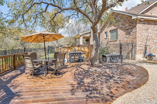 wooden terrace with outdoor dining area and fence