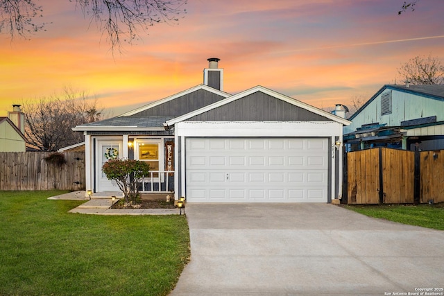 view of front of home with fence, concrete driveway, a chimney, a garage, and a yard