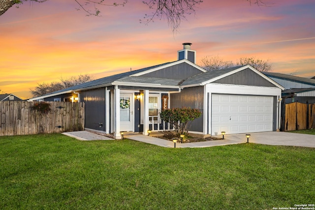 view of front of house featuring fence, a chimney, concrete driveway, a garage, and a lawn