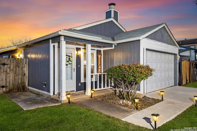 view of front facade featuring an attached garage and fence