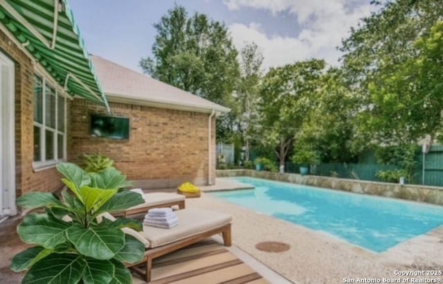 pool featuring a patio area and fence