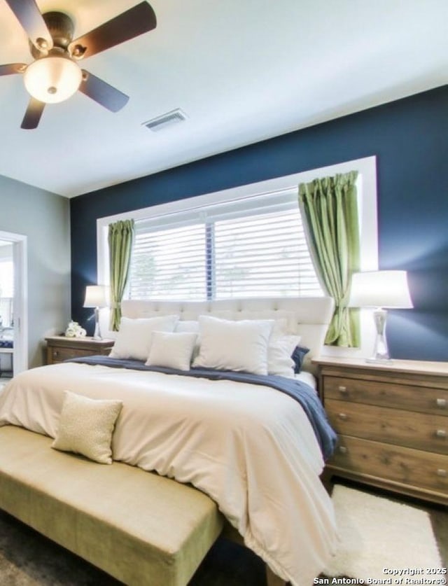 bedroom with visible vents and ceiling fan