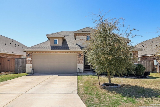 view of front of house with stone siding, a front lawn, a garage, and fence