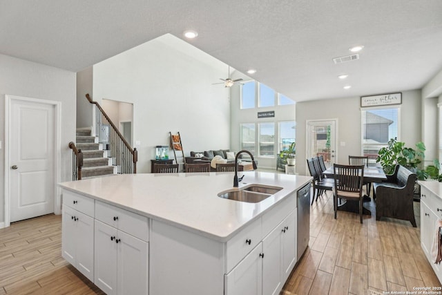 kitchen with a sink, visible vents, wood finish floors, and stainless steel dishwasher