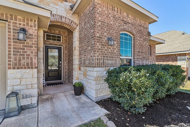 doorway to property with brick siding