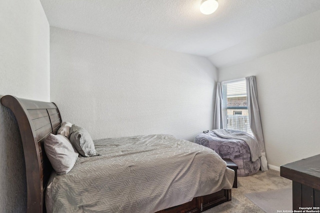 bedroom featuring baseboards, carpet floors, and lofted ceiling