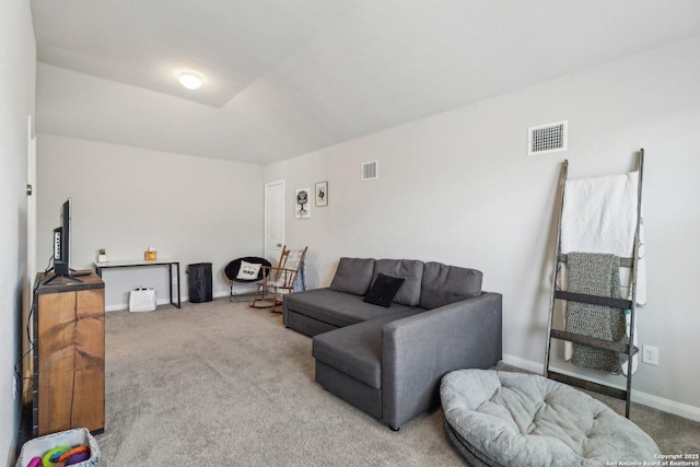 carpeted living area featuring visible vents and baseboards