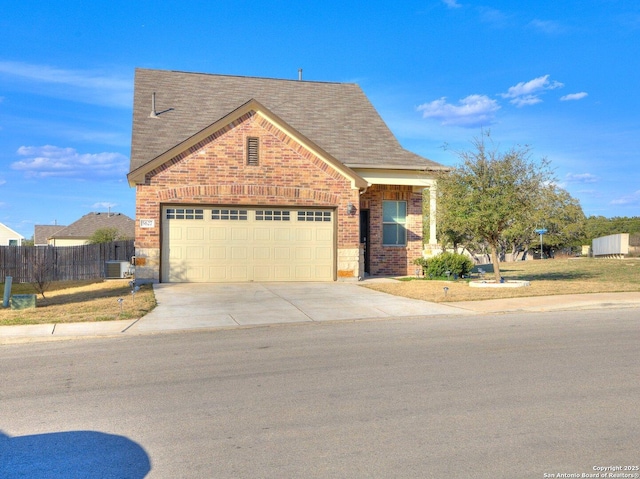 view of front of home featuring fence, roof with shingles, concrete driveway, a garage, and brick siding