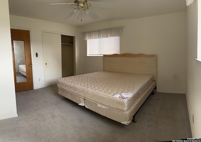 carpeted bedroom featuring a closet, baseboards, and a ceiling fan