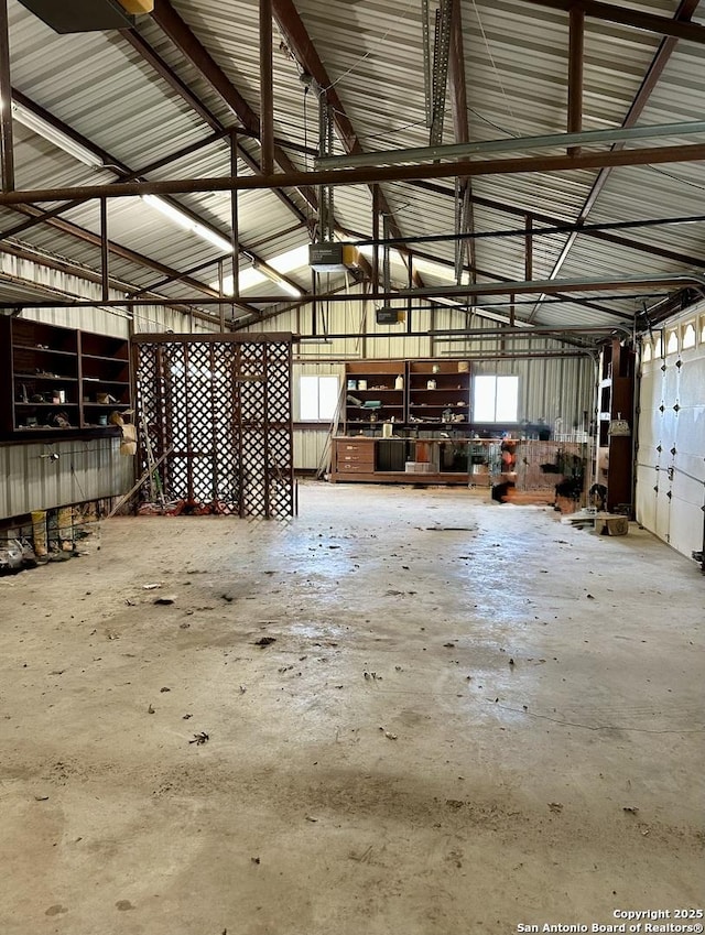 garage featuring a garage door opener and metal wall