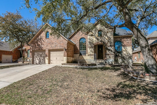 view of front of house with a garage, brick siding, and driveway