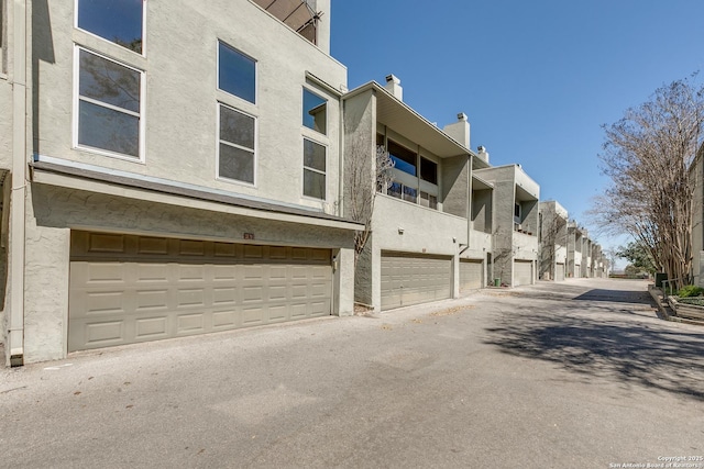 view of property with an attached garage and a residential view