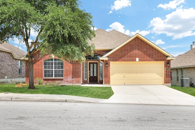 view of front facade with brick siding, a shingled roof, a front lawn, concrete driveway, and a garage