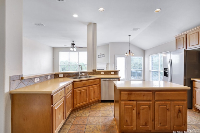 kitchen with visible vents, a sink, a center island, appliances with stainless steel finishes, and light countertops