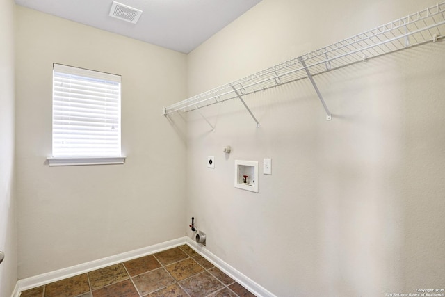 clothes washing area with laundry area, electric dryer hookup, visible vents, and hookup for a gas dryer