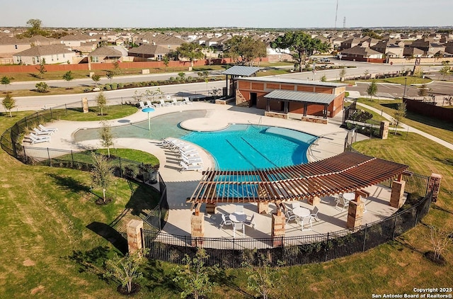 pool with a residential view, a patio, and fence