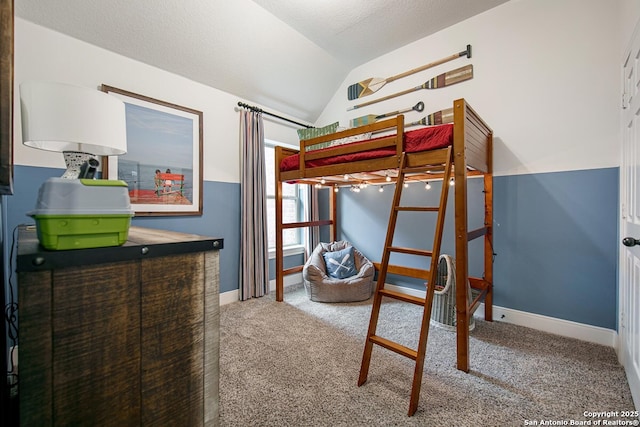 carpeted bedroom with vaulted ceiling, baseboards, and a textured ceiling