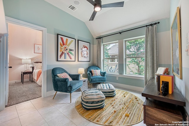 sitting room with visible vents, carpet floors, tile patterned flooring, lofted ceiling, and ceiling fan