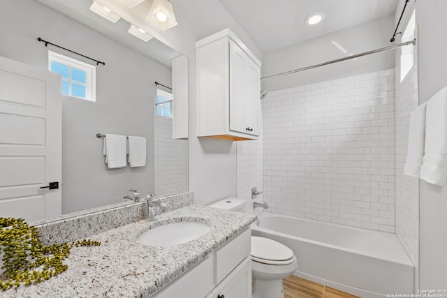 full bath featuring toilet, shower / tub combination, recessed lighting, wood finished floors, and vanity