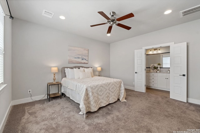 bedroom with recessed lighting, light colored carpet, visible vents, and baseboards